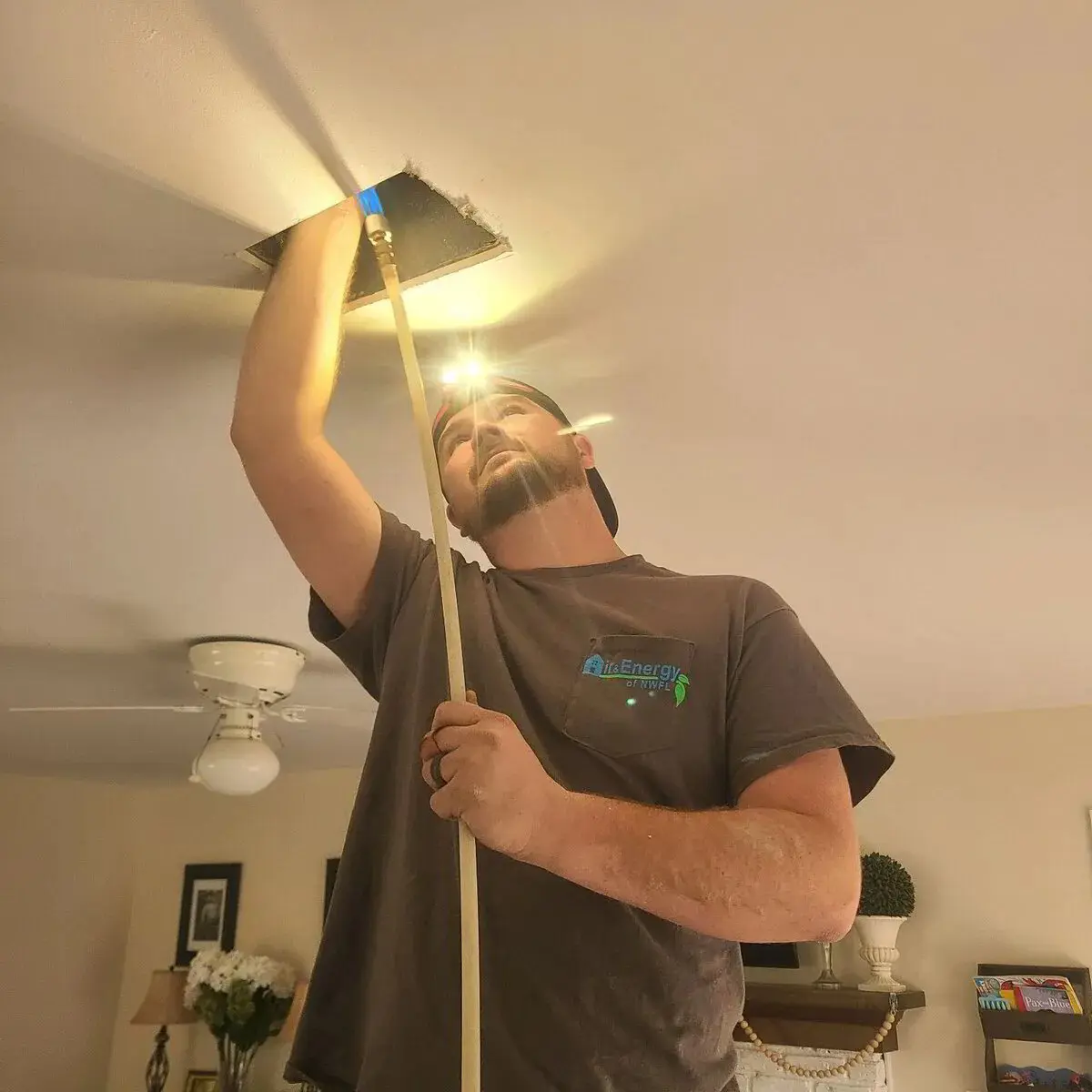 Air and Energy of NWFL technician cleaning air ducts