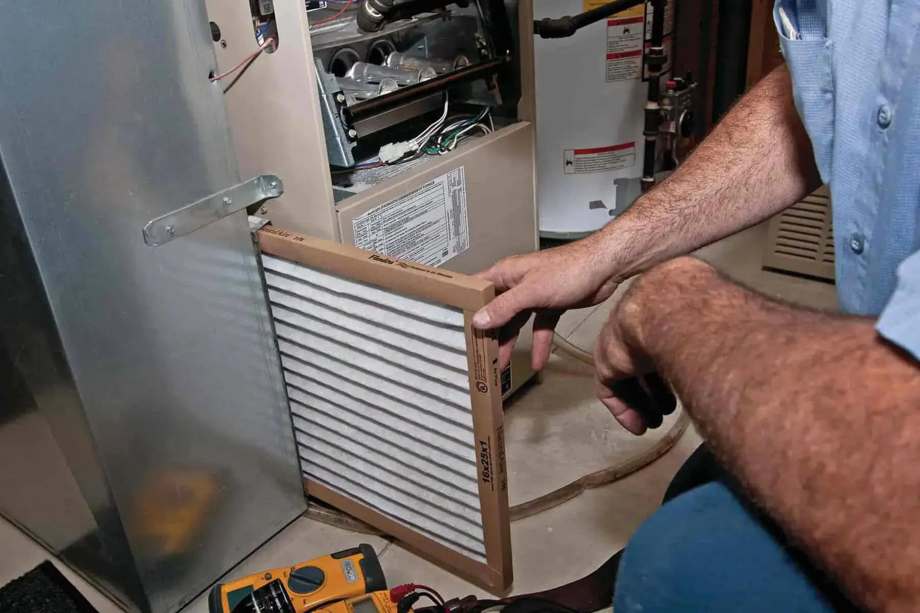 HVAC tech changing a filter