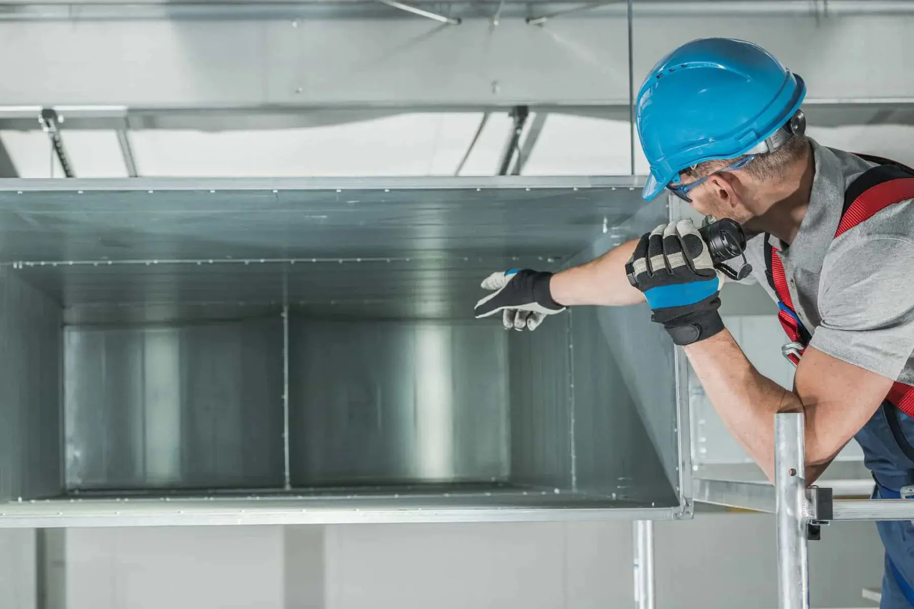 HVAC tech checking air ducts