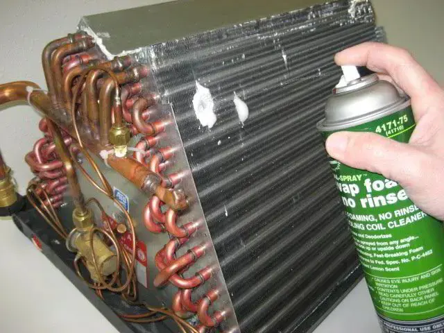 HVAC Technician cleaning an evaporator coil