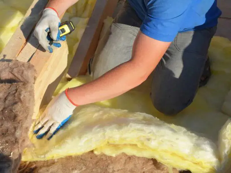 HVAC technician laying in insulation