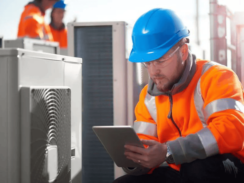 Man performing maintenance on an AC unit