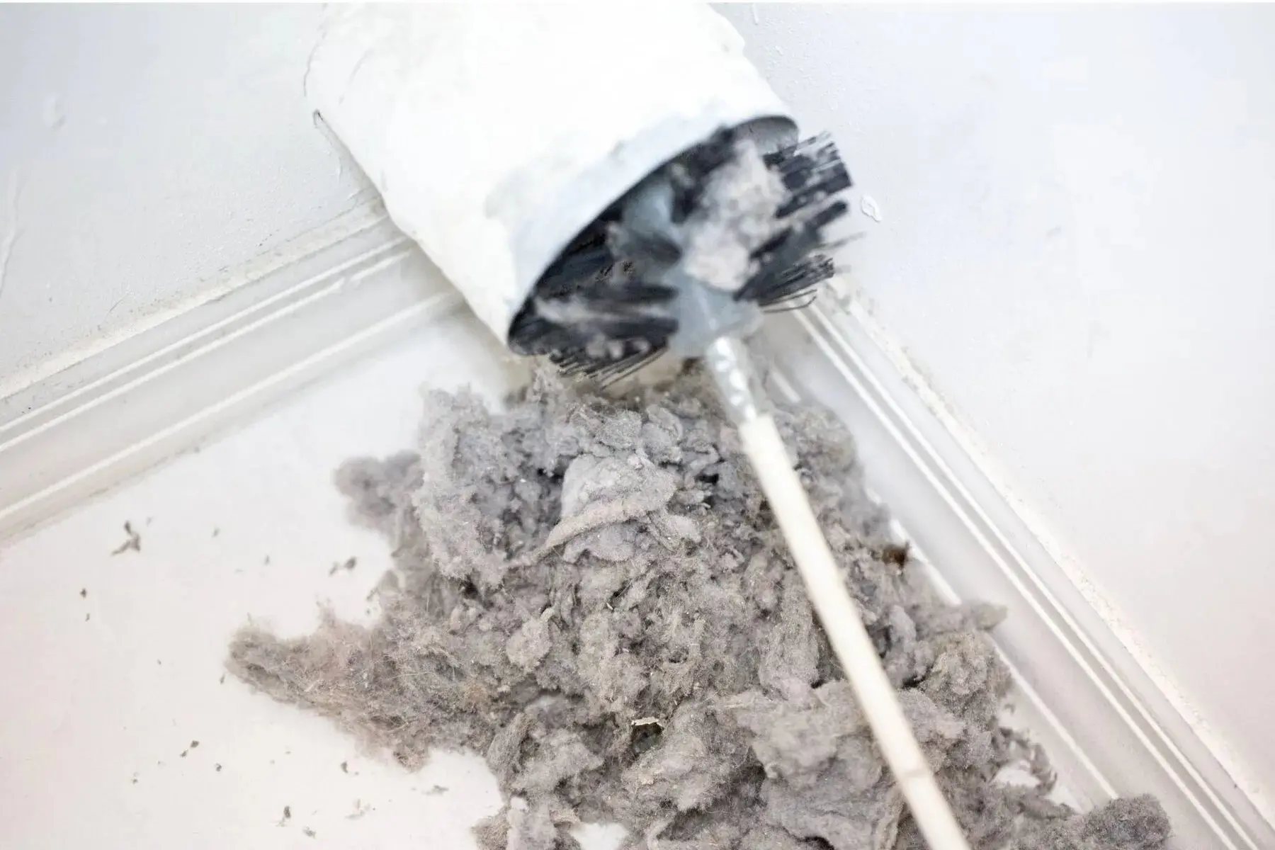 dirty dryer vent being cleaned