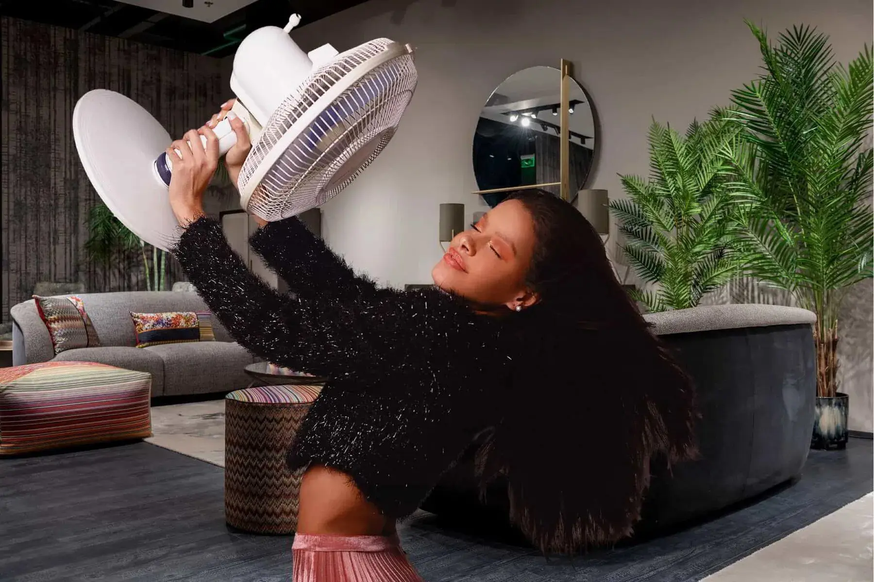 woman with a fan in a hot room